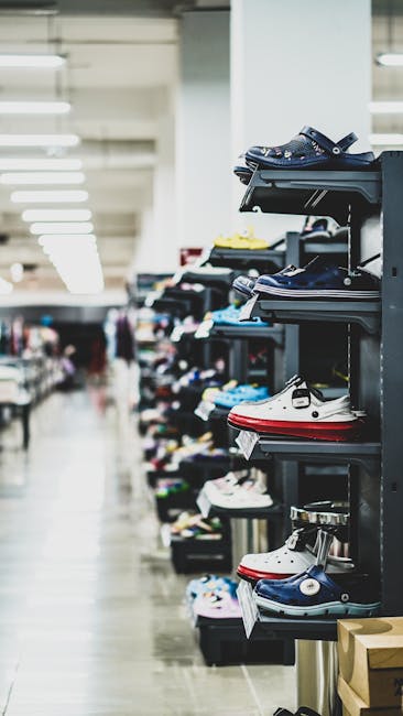 A wide selection of shoes neatly arranged in a store aisle in Birgunj, Nepal.